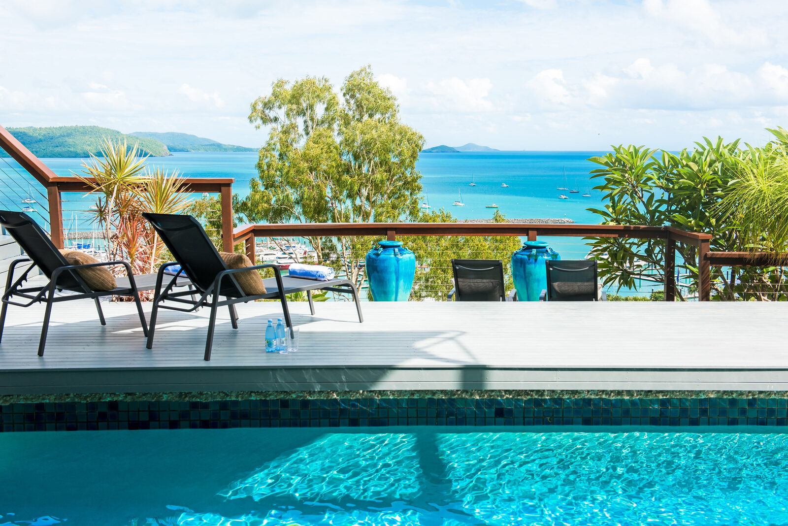 Sun loungers beside the pool with sea views